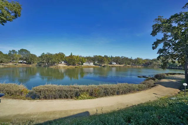 a view of a lake with houses in the background