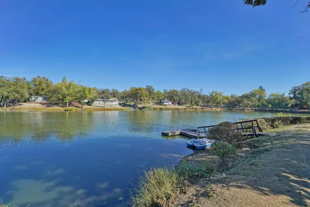 an aerial view of a house with a lake view