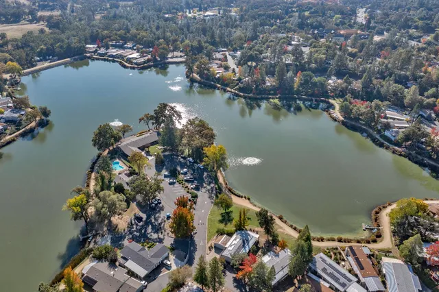 an aerial view of water body with boats and residential houses with outdoor seating