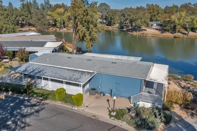 an aerial view of a house with a lake view