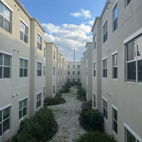 a view of a residential apartment building with a yard