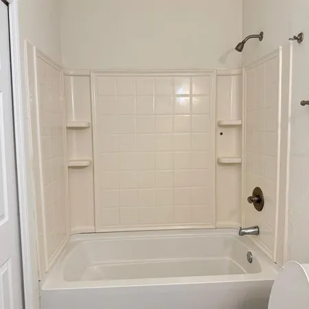 a bathroom with a bathtub and shower