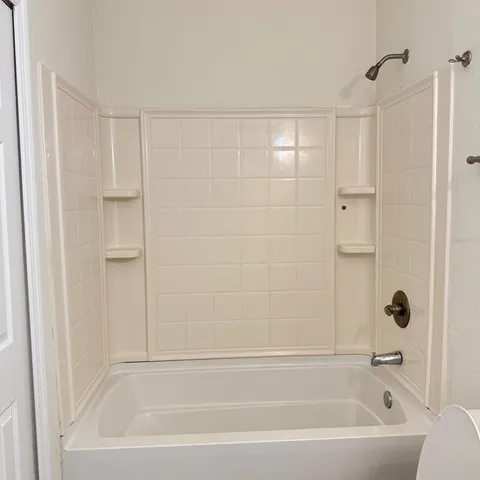 a bathroom with a bathtub and shower