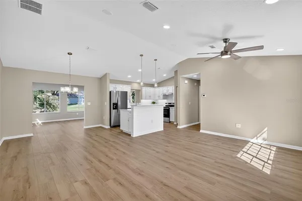 a view of a kitchen with wooden floor and a kitchen