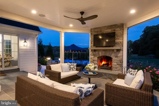 a living room with furniture a large window and a dining table
