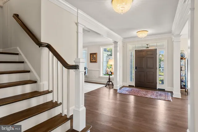 a living room with furniture a fireplace a flat screen tv and a large window