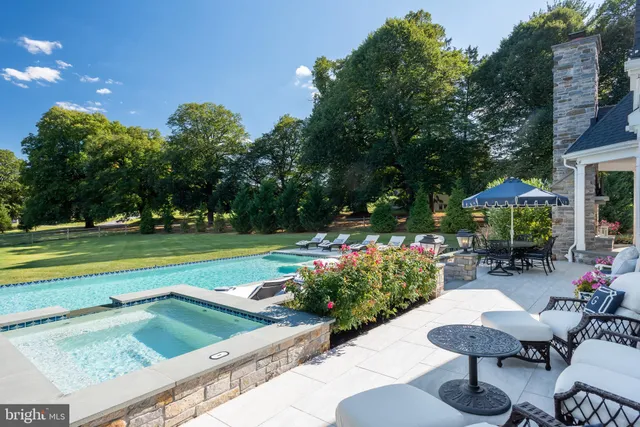 a kitchen with a stove a sink a dining table and chairs