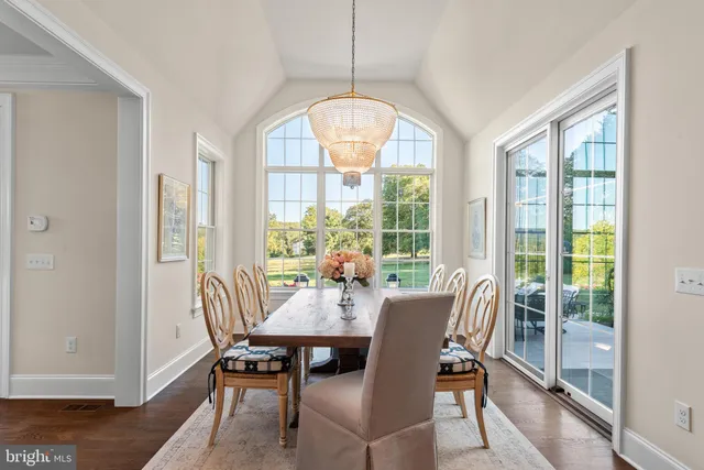 a view of a hallway with wooden floor and entryway