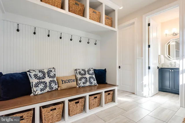 a bathroom with a sink a toilet a mirror and a shower