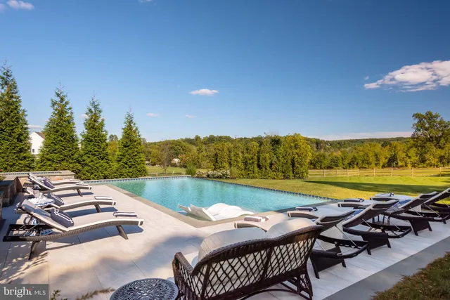 a view of a chairs and table in patio with a yard