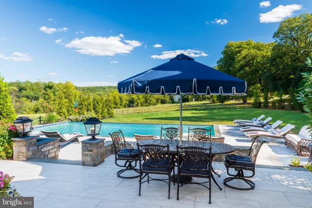 a view of swimming pool with seating area and yard view