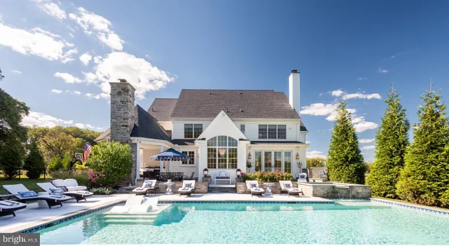 a living room with fireplace furniture and a floor to ceiling window