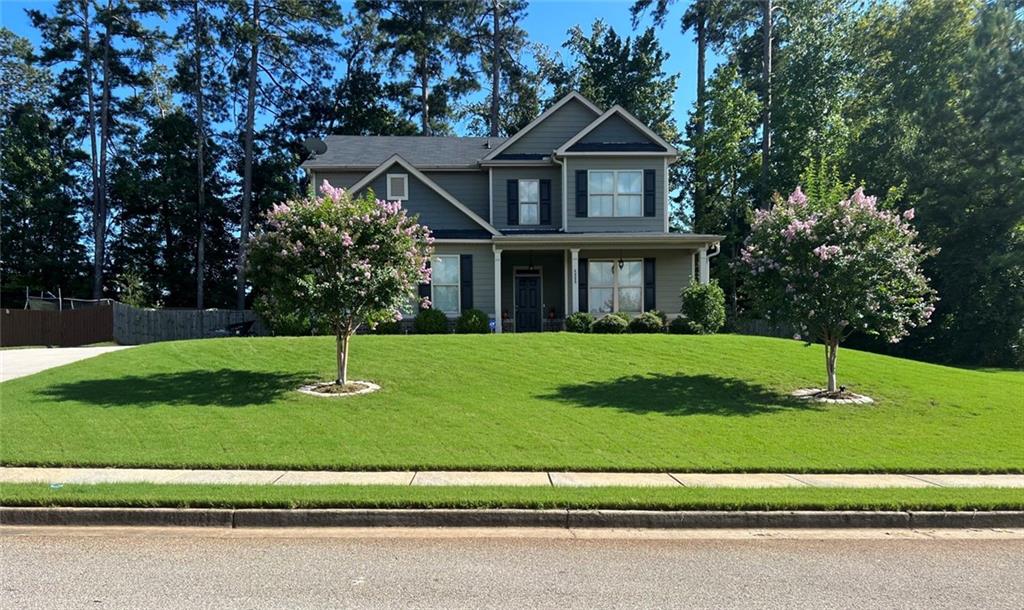 a front view of a house with a yard