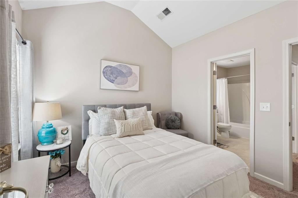 4065 McClendon Way Rex, GA 30273 - Photo 11 of 16 a bedroom with a bed and a painting on the wall