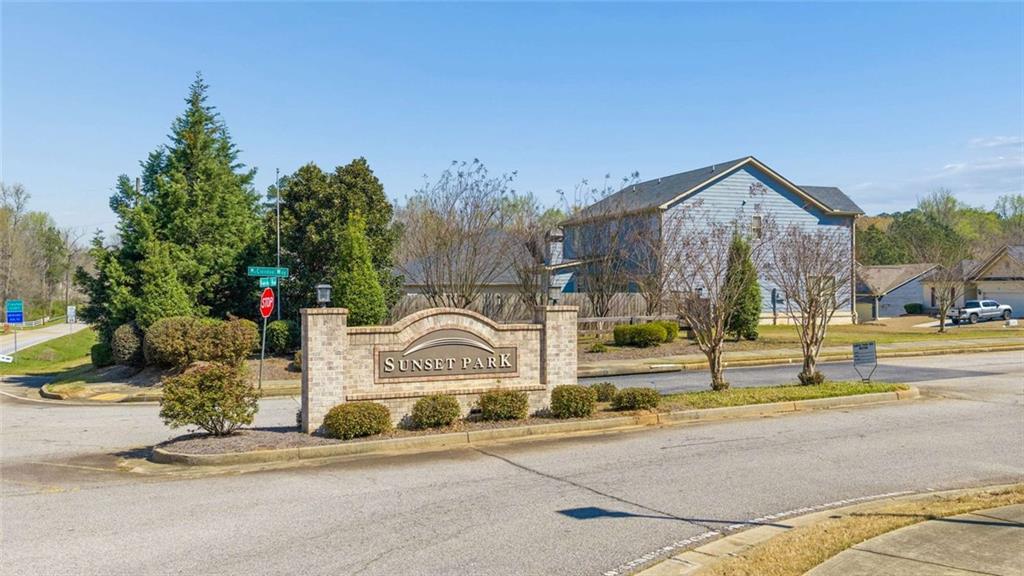 4065 McClendon Way Rex, GA 30273 - Photo 3 of 16 a front view of a house with a garden and tree