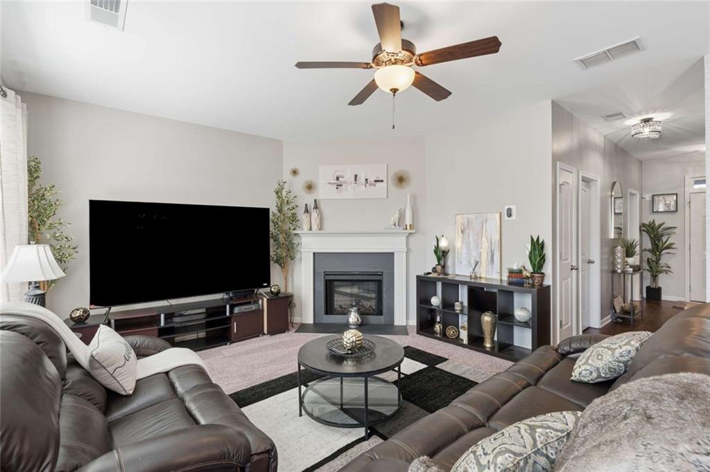 4065 McClendon Way Rex, GA 30273 - Photo 8 of 16 a living room with furniture a fireplace and a flat screen tv