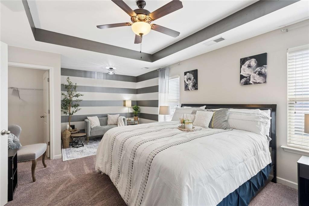 4065 McClendon Way Rex, GA 30273 - Photo 9 of 16 a bedroom with bed and a chandelier