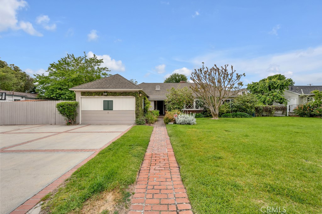 a front view of a house with yard and green space