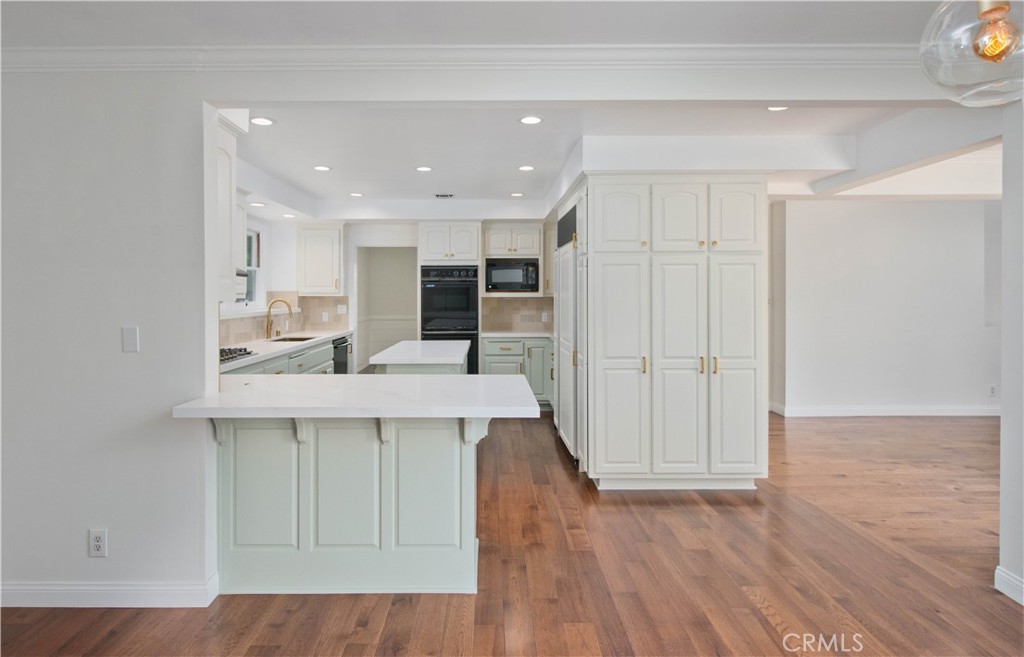 4722 Forman Lane Toluca Lake, CA 91602 - Photo 14 of 52 a kitchen with kitchen island a sink stainless steel appliances and cabinets