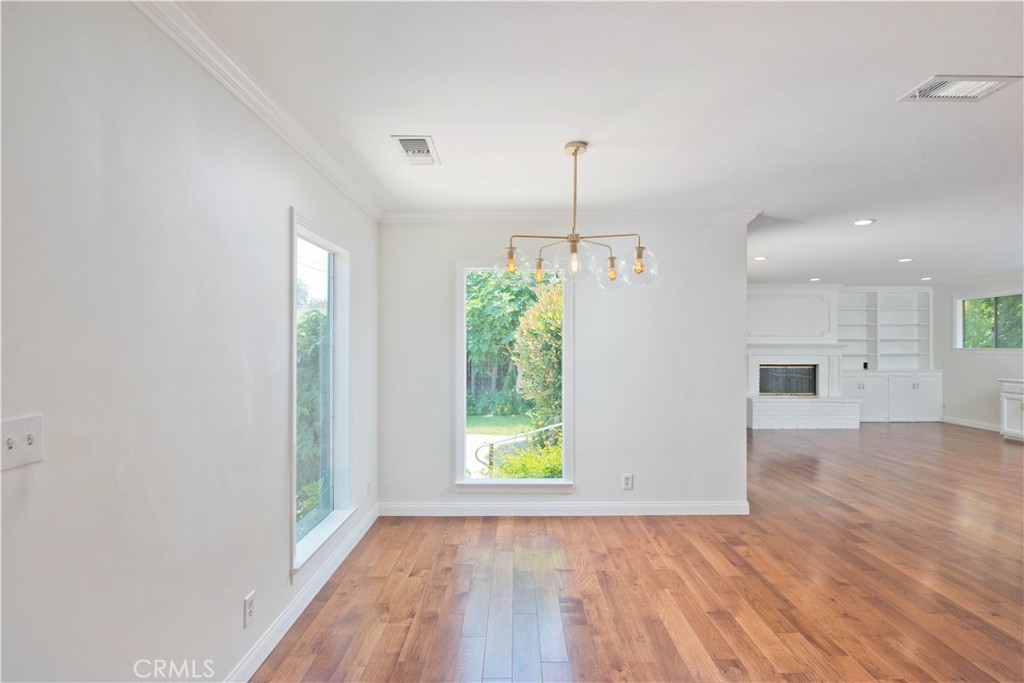 4722 Forman Lane Toluca Lake, CA 91602 - Photo 15 of 52 a view of empty room with wooden floor and window
