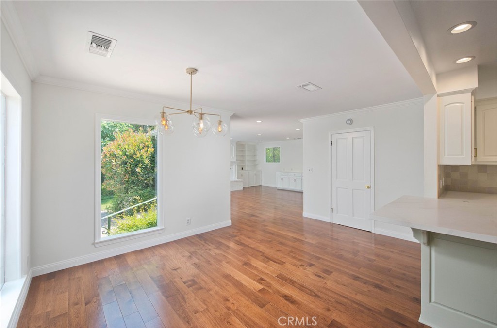 4722 Forman Lane Toluca Lake, CA 91602 - Photo 16 of 52 a view of an empty room with wooden floor and a window