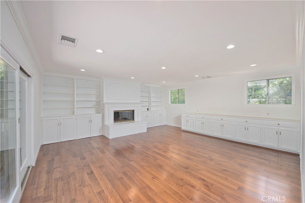 4722 Forman Lane Toluca Lake, CA 91602 - Photo 18 of 52 an empty room with wooden floor and windows