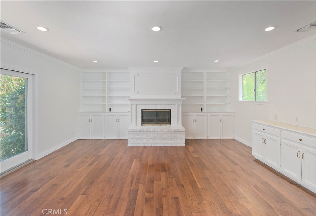 4722 Forman Lane Toluca Lake, CA 91602 - Photo 19 of 52 an empty room with windows and fireplace