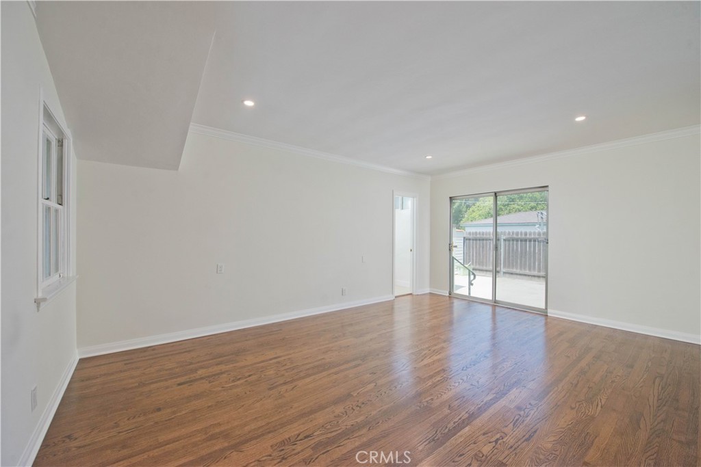 4722 Forman Lane Toluca Lake, CA 91602 - Photo 24 of 52 a view of an empty room with wooden floor and a window