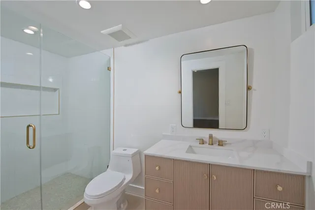 a bathroom with a shower and toilet