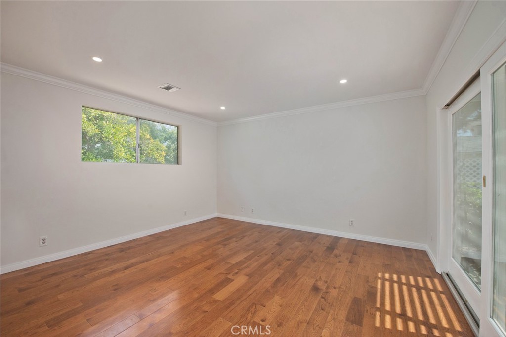 4722 Forman Lane Toluca Lake, CA 91602 - Photo 28 of 52 an empty room with wooden floor and windows