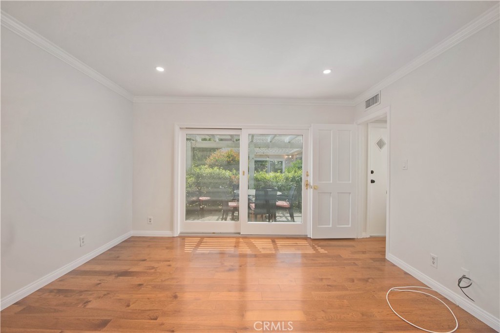 4722 Forman Lane Toluca Lake, CA 91602 - Photo 29 of 52 a view of an empty room with wooden floor and a window