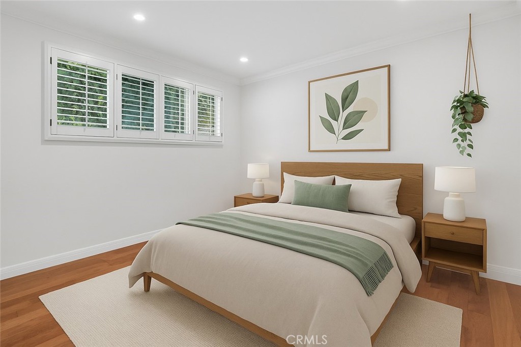 4722 Forman Lane Toluca Lake, CA 91602 - Photo 33 of 52 a bedroom with a bed and a painting on the wall