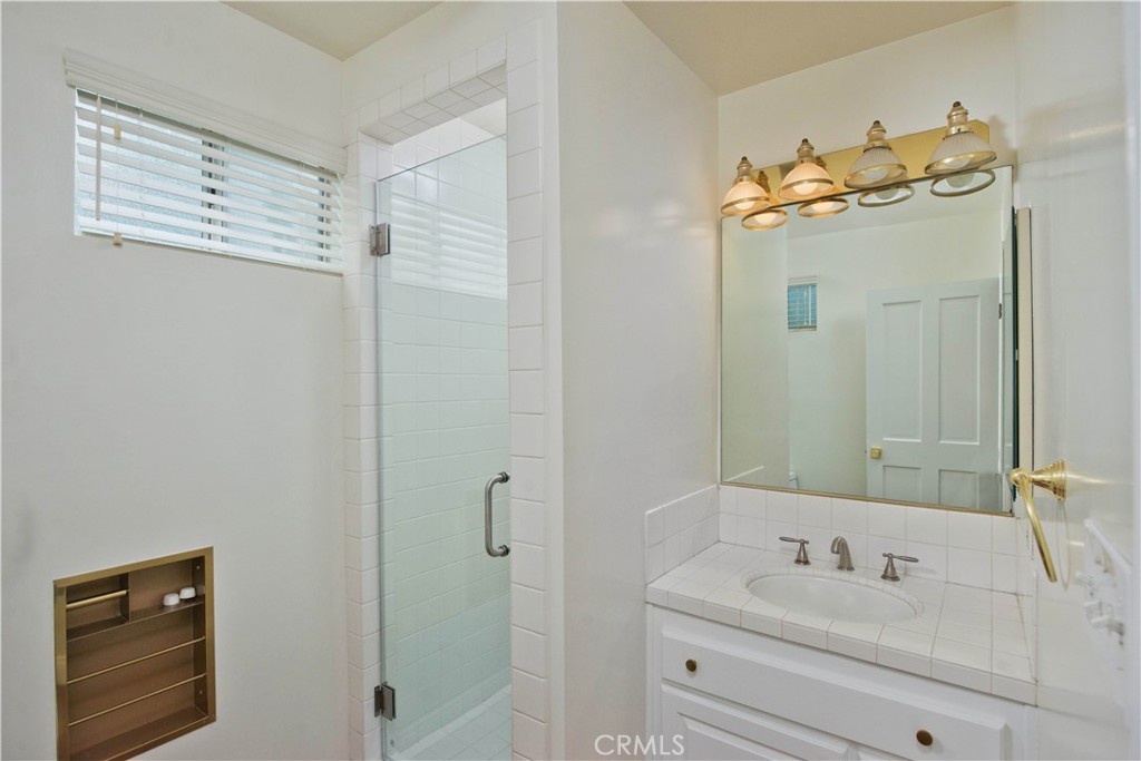 4722 Forman Lane Toluca Lake, CA 91602 - Photo 39 of 52 a bathroom with a sink and mirror