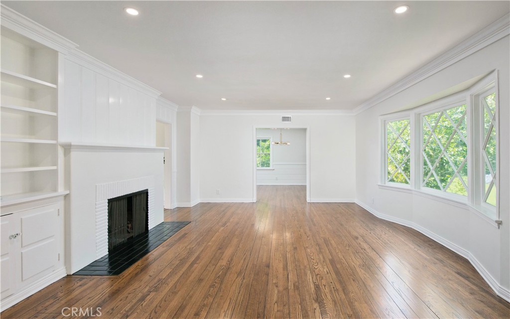 4722 Forman Lane Toluca Lake, CA 91602 - Photo 4 of 52 a view of empty room with wooden floor and fireplace