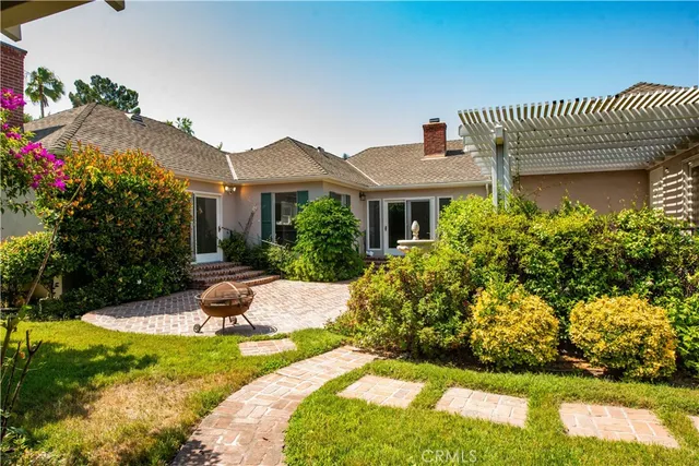 a front view of a house with a yard and fountain