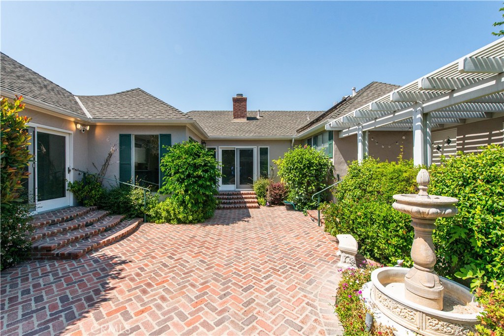 4722 Forman Lane Toluca Lake, CA 91602 - Photo 45 of 52 a front view of a house with a yard and fountain