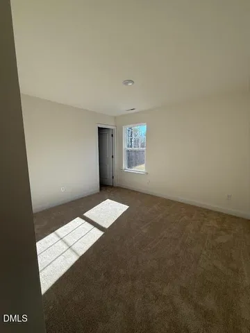a view of wooden floor and windows in a room