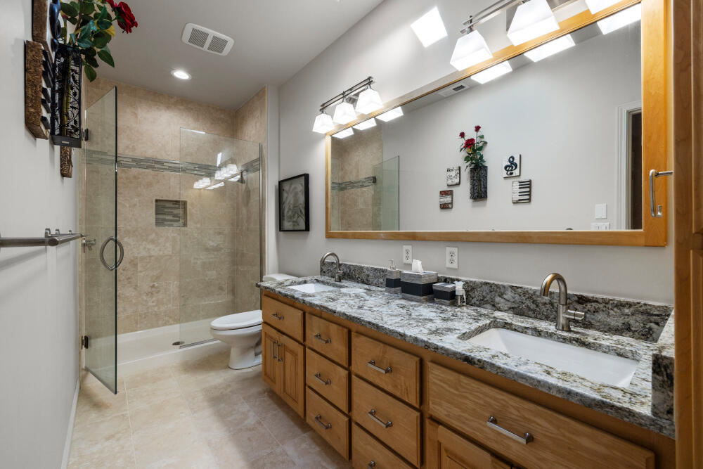 11629 Merganser Road Klamath Falls, OR 97601 - Photo 48 of 50 a bathroom with a granite countertop sink a toilet a mirror and shower
