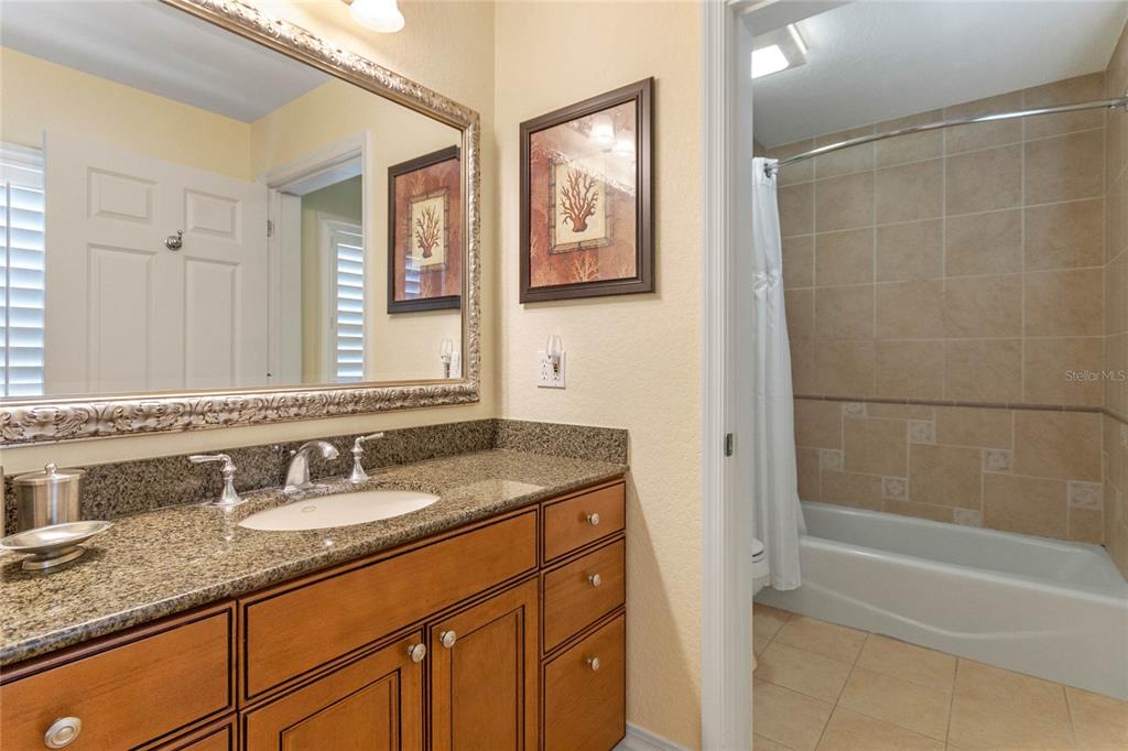 1106 Sunset View Circle, Unit 201 Reunion, FL 34747 - Photo 11 of 31 a bathroom with a granite countertop sink mirror and a bath tub