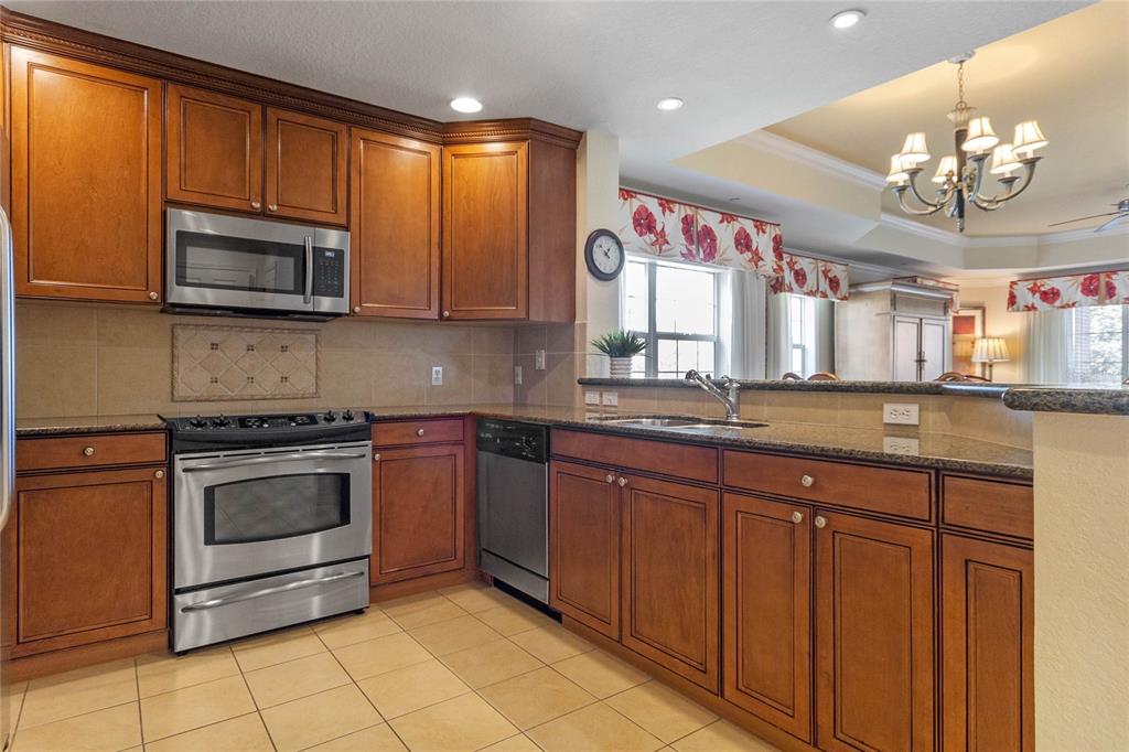 1106 Sunset View Circle, Unit 201 Reunion, FL 34747 - Photo 5 of 31 a kitchen with stainless steel appliances granite countertop a stove and cabinets