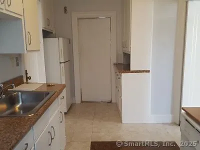 a kitchen with a sink and a refrigerator