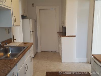 211 Fountain Street New Haven, CT 06515 - Photo 12 of 19 a kitchen with a sink and a refrigerator