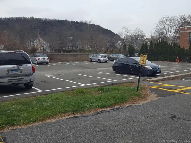a view of a street with a cars parked on the road