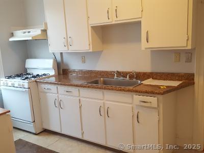 211 Fountain Street New Haven, CT 06515 - Photo 9 of 19 a kitchen with granite countertop white cabinets and a sink