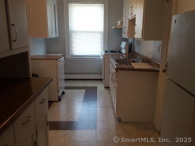 211 Fountain Street New Haven, CT 06515 - Photo 10 of 19 a kitchen with a refrigerator and a stove