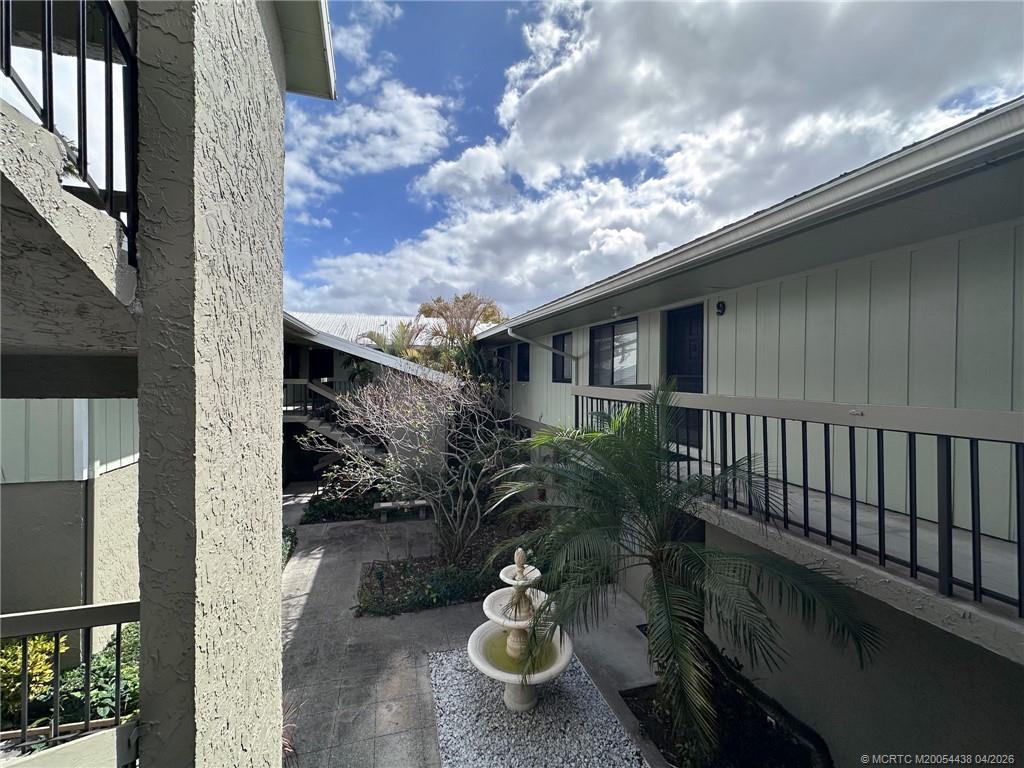 800 Northwest Fork Road, Unit 107 Stuart, FL 34994 - Photo 13 of 21 a balcony with furniture and a potted plant