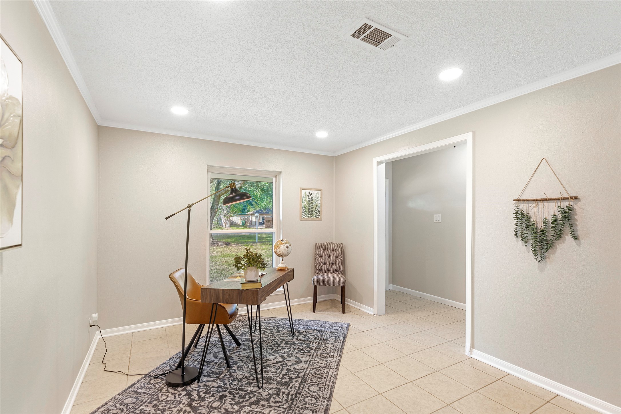 Just off the front entryway is the living/dining room combo, currently staged as a small office area.