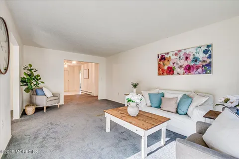 a view of a room with wooden floor and white walls