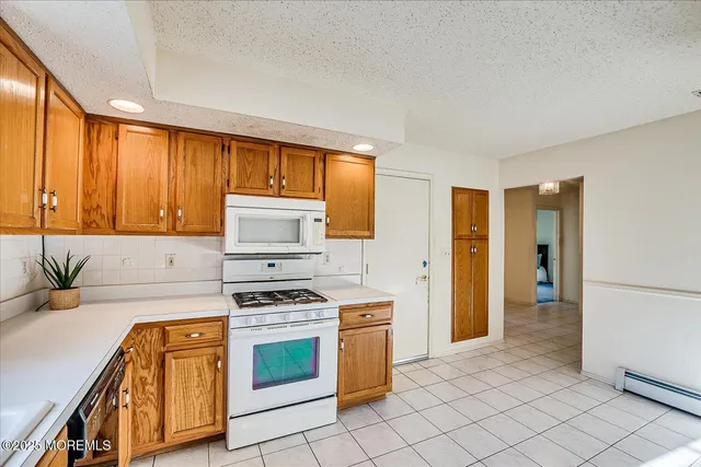 a spacious bedroom with a bed and a mirror