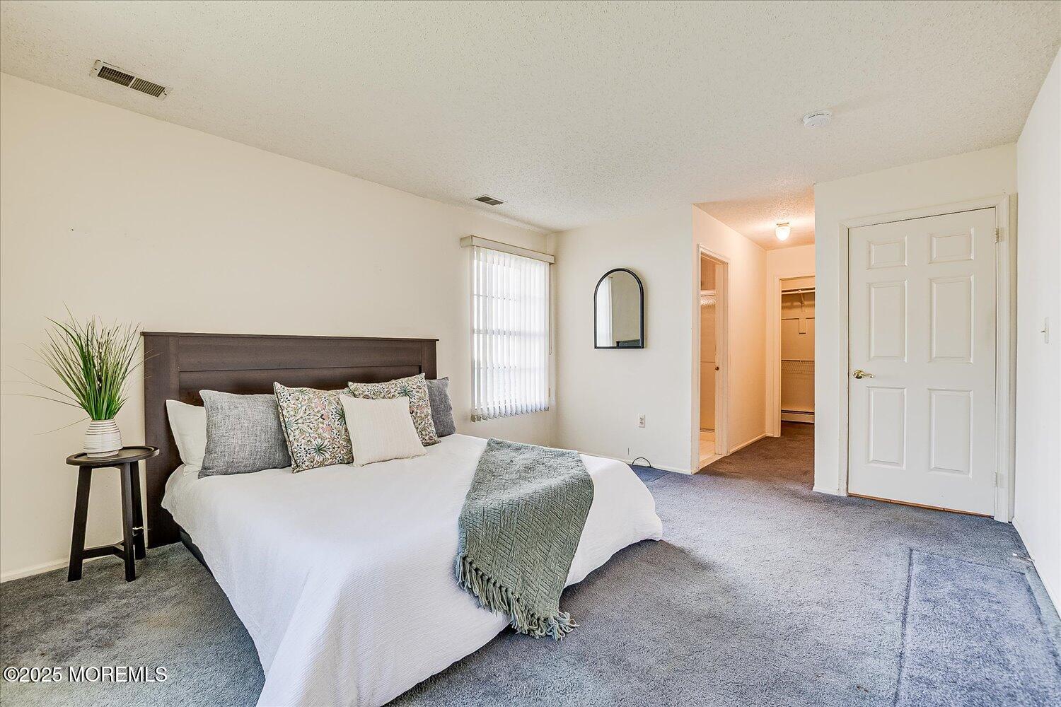 36 Sleepy Hollow Drive Brick, NJ 08724 - Photo 24 of 47 a spacious bedroom with a bed and a mirror